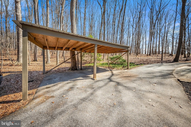 view of patio / terrace with a detached carport and aphalt driveway