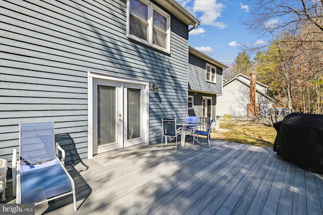 wooden deck featuring a grill and fence