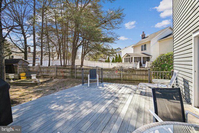 wooden terrace featuring fence