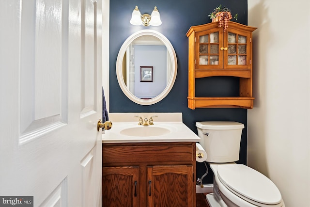 bathroom featuring toilet and vanity