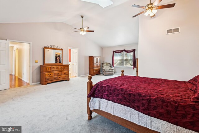 bedroom featuring visible vents, a skylight, carpet flooring, baseboards, and ceiling fan