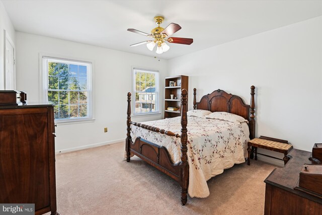 bedroom with baseboards, light carpet, and ceiling fan