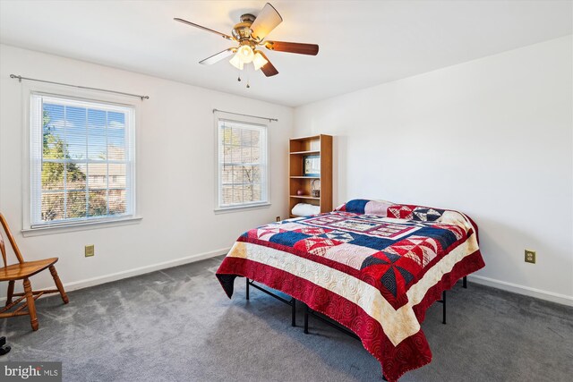 bedroom with baseboards, multiple windows, carpet, and a ceiling fan