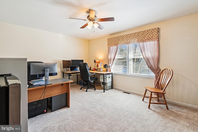 home office with a ceiling fan, carpet, visible vents, and baseboards