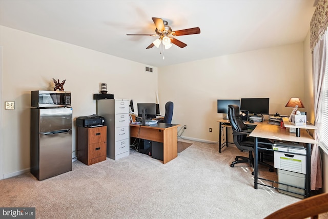 home office featuring baseboards, carpet, visible vents, and ceiling fan