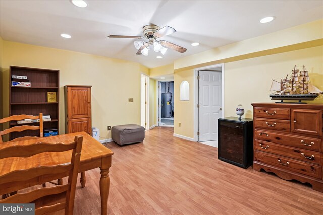 bedroom featuring recessed lighting, baseboards, light wood-style floors, and water heater