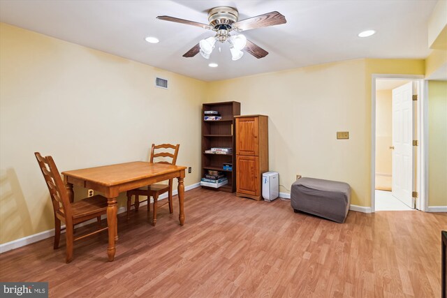 dining area featuring light wood finished floors, visible vents, and baseboards