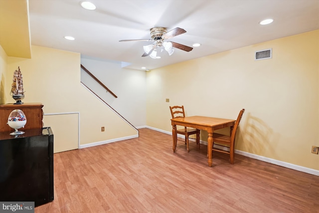 dining room with light wood-type flooring, visible vents, baseboards, and a ceiling fan