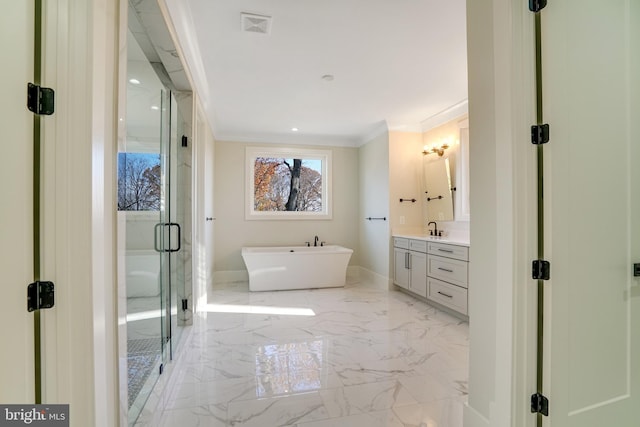 full bath featuring a stall shower, a soaking tub, marble finish floor, crown molding, and vanity