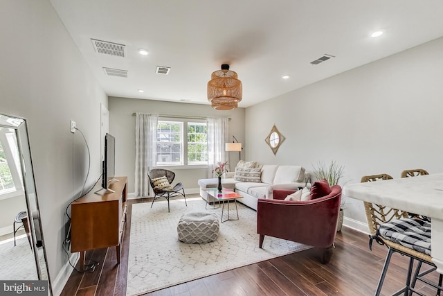 living area with dark wood-style floors and visible vents