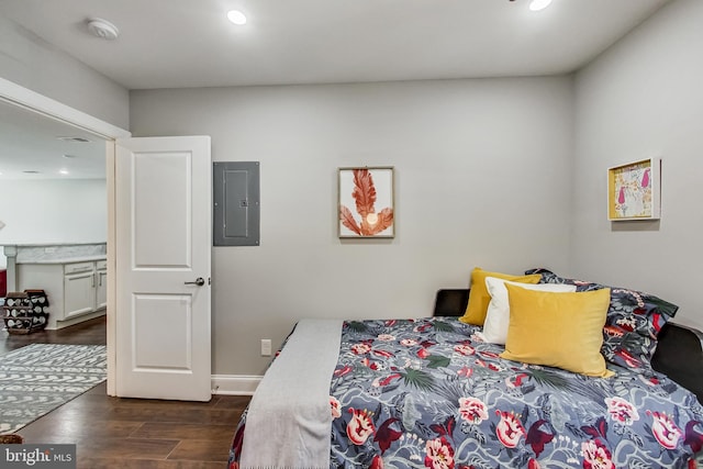 bedroom with electric panel, baseboards, dark wood finished floors, and recessed lighting