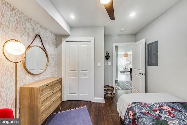 bedroom with wallpapered walls, electric panel, baseboards, dark wood-type flooring, and recessed lighting