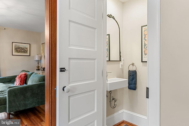 bathroom with baseboards and wood finished floors