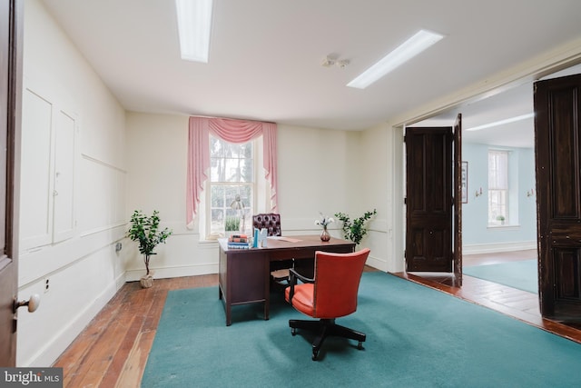 office space with wood-type flooring and baseboards