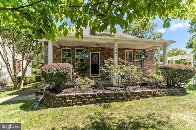 view of front of home with stone siding, covered porch, and a front lawn