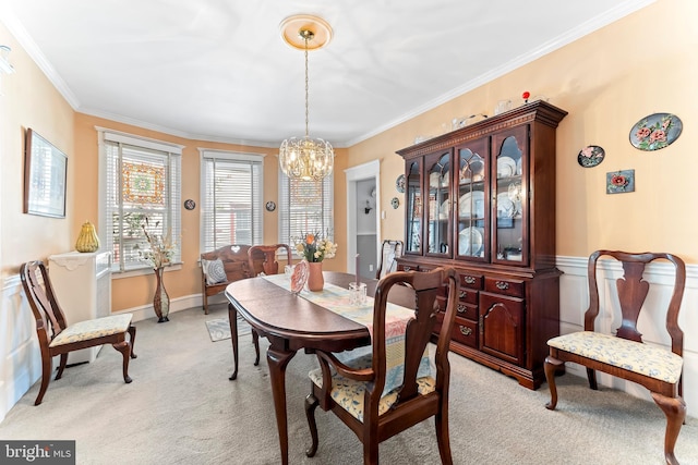 dining area featuring light carpet, an inviting chandelier, and crown molding