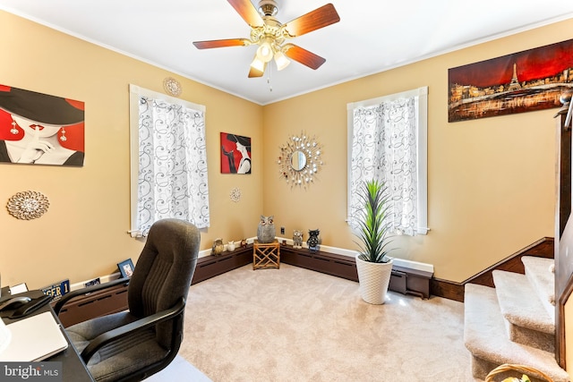 carpeted home office with a ceiling fan and baseboards