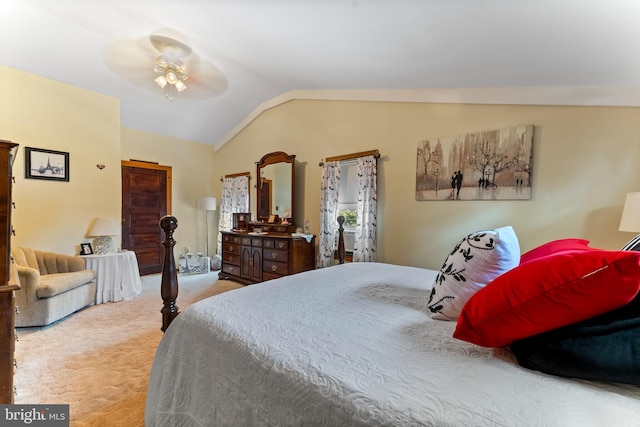 bedroom with vaulted ceiling, ceiling fan, and light carpet