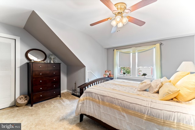 bedroom featuring lofted ceiling, a ceiling fan, and light colored carpet