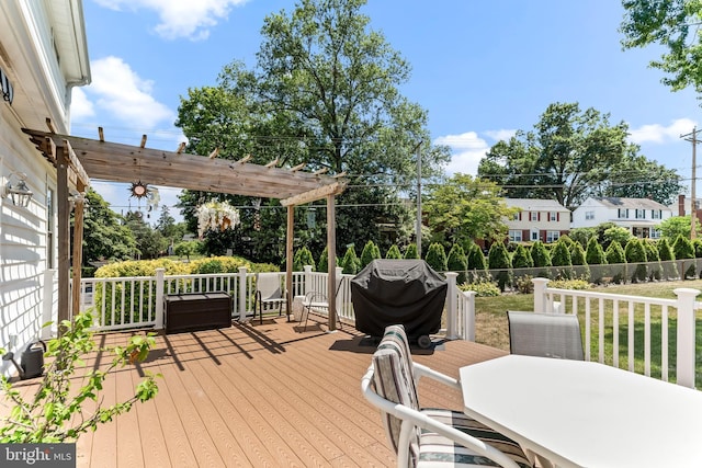 wooden terrace featuring outdoor dining space, a yard, and a pergola