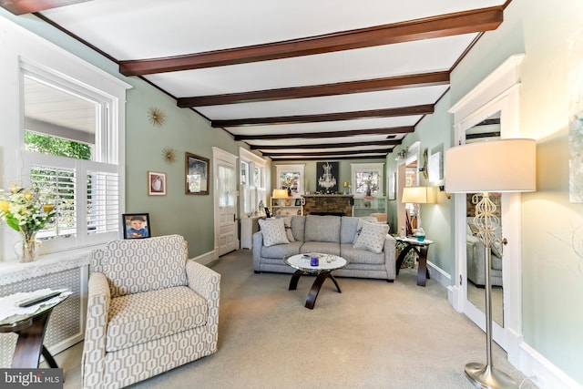 living room with baseboards, beamed ceiling, and light colored carpet