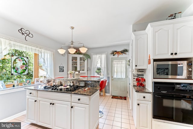 kitchen with white cabinetry, plenty of natural light, and black appliances