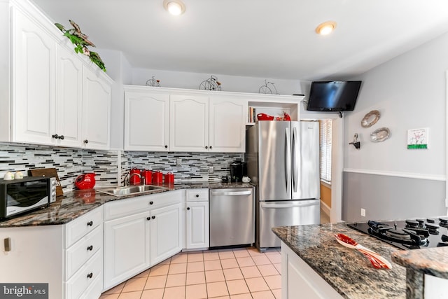 kitchen featuring stainless steel appliances, a sink, and white cabinets