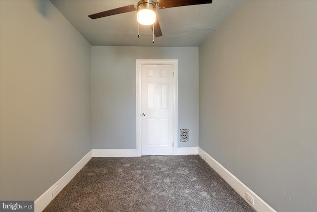 carpeted empty room featuring a ceiling fan and baseboards
