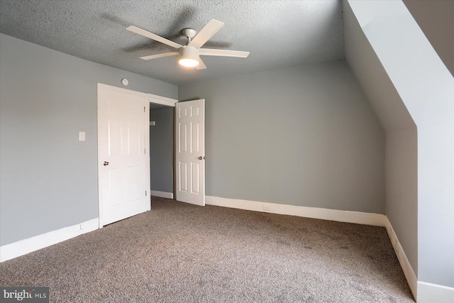 interior space featuring carpet floors, ceiling fan, baseboards, and a textured ceiling
