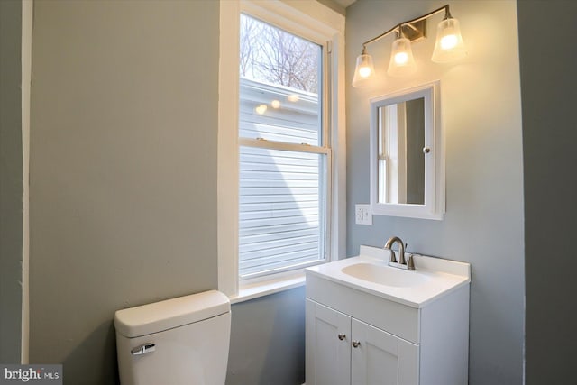 bathroom with toilet and vanity