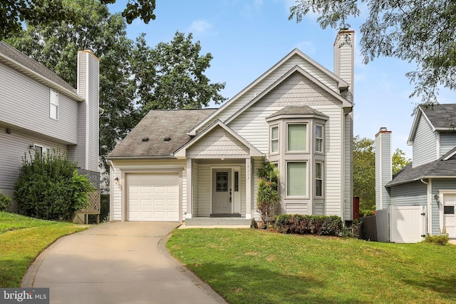 view of front facade with a garage, driveway, a chimney, and a front yard