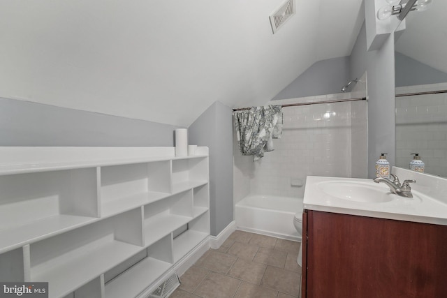 full bath featuring visible vents, tub / shower combination, vaulted ceiling, vanity, and tile patterned flooring