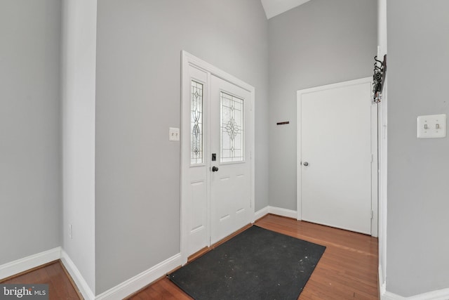 foyer entrance featuring baseboards and wood finished floors