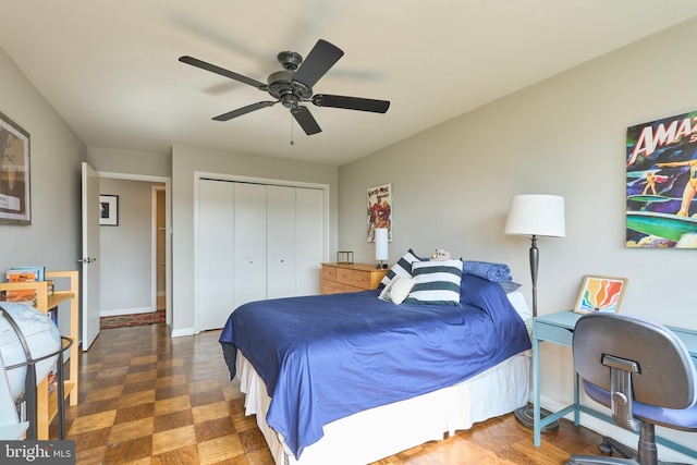 bedroom with ceiling fan, baseboards, and a closet