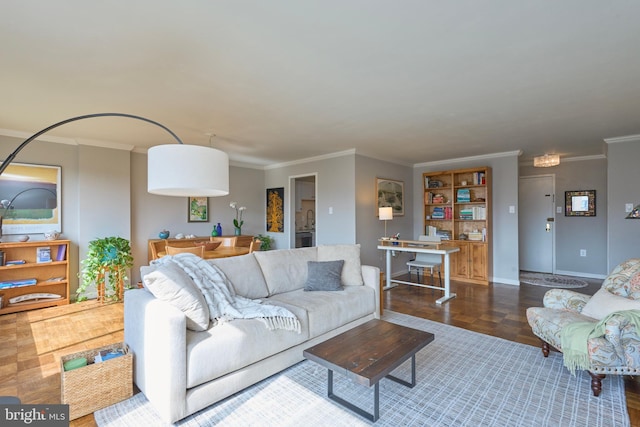 living room with crown molding, baseboards, and wood finished floors