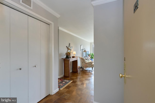 hall featuring ornamental molding, visible vents, and baseboards