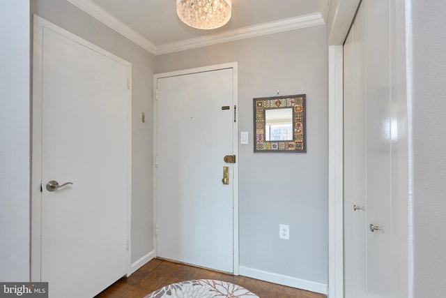 entryway with baseboards and crown molding