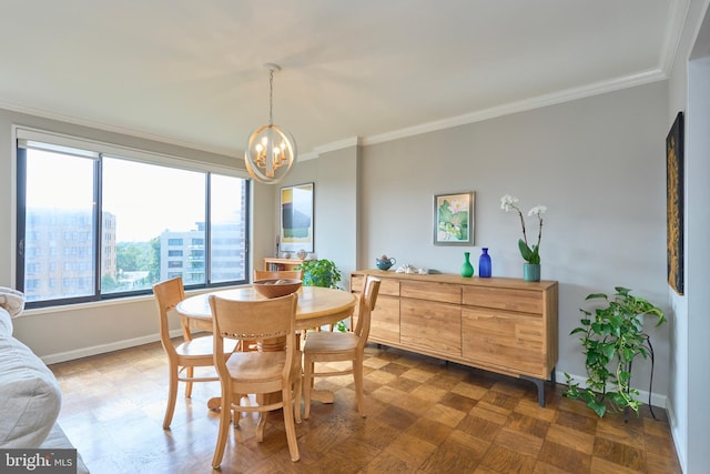 dining area with a notable chandelier, crown molding, and baseboards