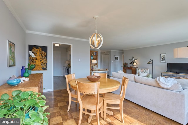 dining area featuring a chandelier, ornamental molding, and baseboards