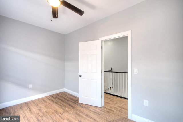 unfurnished bedroom featuring light wood-type flooring, a ceiling fan, and baseboards