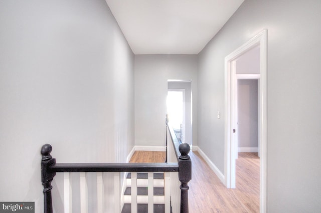 stairway with baseboards and wood finished floors