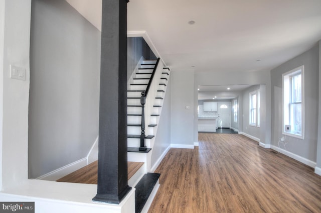 interior space featuring stairs, wood finished floors, and baseboards