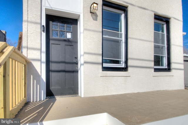 doorway to property with stucco siding