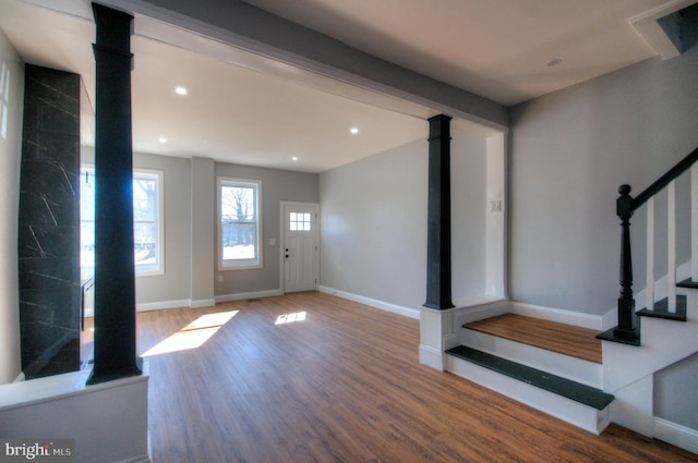 entrance foyer featuring stairs, baseboards, wood finished floors, and recessed lighting