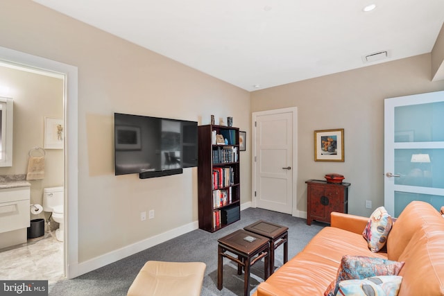 living room featuring carpet floors, visible vents, and baseboards