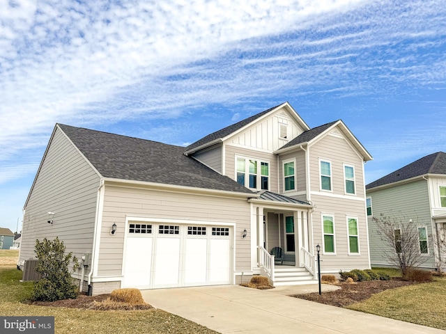 view of front of property with central air condition unit, a garage, concrete driveway, roof with shingles, and board and batten siding