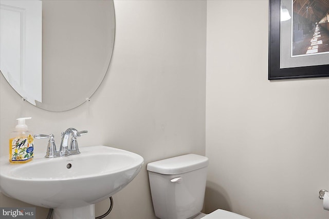 bathroom featuring toilet and a sink