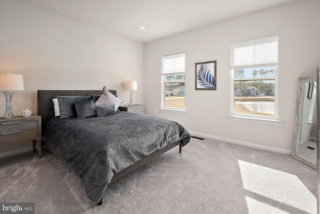 carpeted bedroom featuring recessed lighting, visible vents, and baseboards