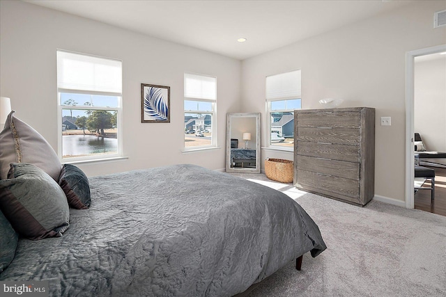 carpeted bedroom with recessed lighting, visible vents, and baseboards