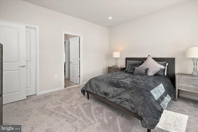 carpeted bedroom featuring baseboards and recessed lighting